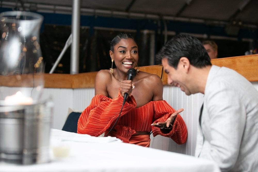 Patina Miller with mic in hand, laughing with interviewer