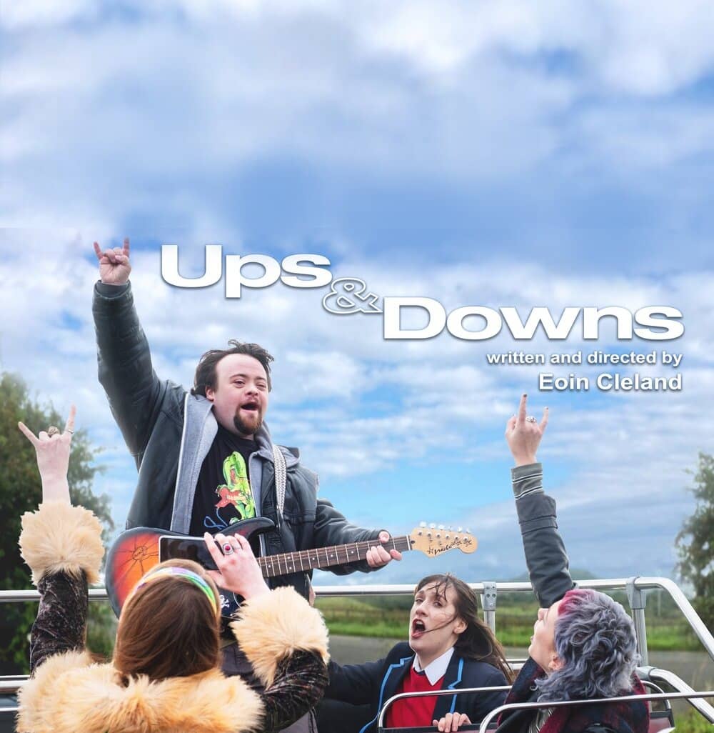 Up & Downs movie poster with man with downs syndrome happily playing guitar on the top of a tour bus